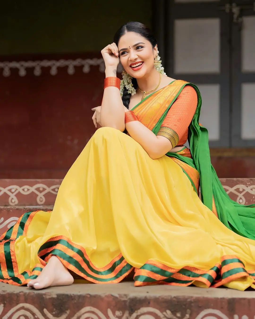 Sreemukhi Stills in Yellow Lehenga Orange Choli Green Voni